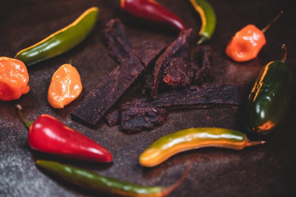 Beef jerky with colored peppered on brown