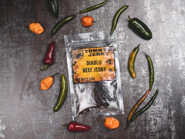 Beef jerky in bag with colored peppered on brown
