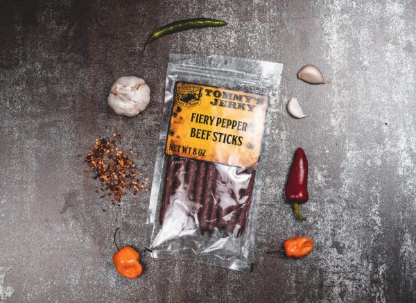 Fiery pepper beef stick in bag with garlic, peppers, and spices