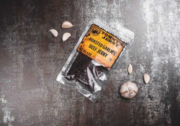 Beef jerky in bag with garlic on brown